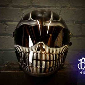 Black motorcycle helmet with detailed white skull design featuring realistic jaw bones and teeth, gothic style airbrush work